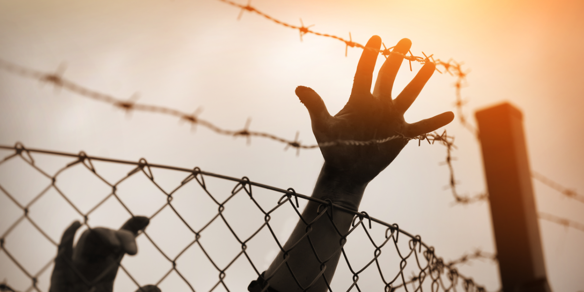 Hands, fence.